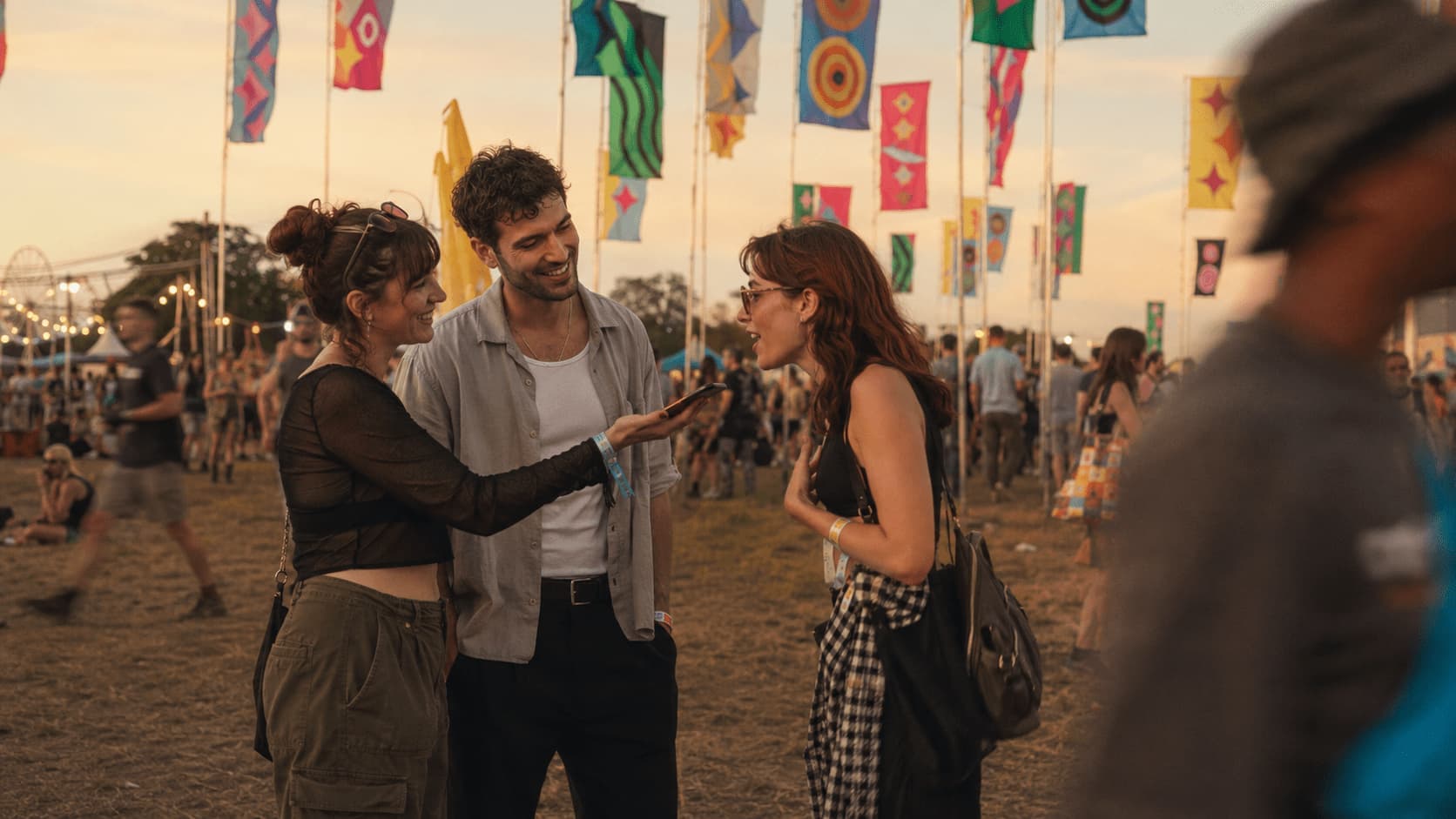 Friends laughing and recording a voice review together at a festival